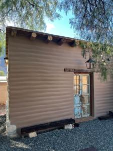 a garage with a window on the side of it at La Ventanita de Maima in Maimará +9 photos