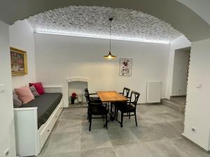 a room with a table and chairs and a bed at Pension Phoenix in Znojmo