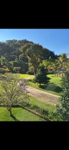 a view of a park with trees and grass at Adriana Rinaldi Gonçalves in Angra dos Reis