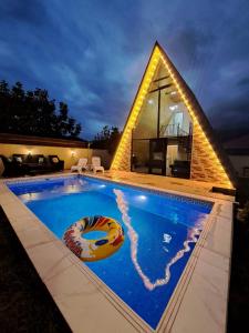 a swimming pool in front of a house at Gabala Twin A Frame Villas in Gabala