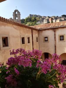 a building with purple flowers in front of it at Al Convento in San Mauro Castelverde