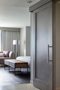 a hotel room with a door leading to a bedroom at Raleigh Marriott City Center in Raleigh