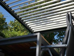 awning over a table with trees in the background at Studio ELITE in Bled +37 photos