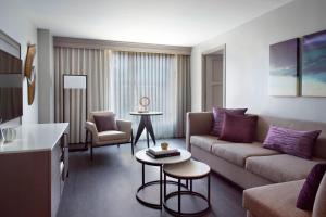 a living room with a couch and a table at Raleigh Marriott City Center in Raleigh +40 photos