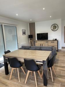 a living room with a large wooden table and chairs at Gîte la Chotinière in Mareuil-sur-Cher