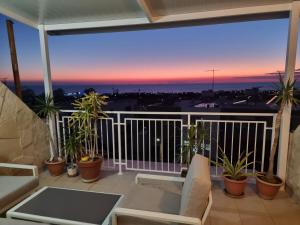 a balcony with a view of a sunset at MEDITERRANEAN VALLEY in Paphos City