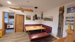 a dining room with a wooden table and a bench at Haidegger Appartements in Innsbruck