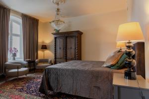 een slaapkamer met een bed en een tafel met een lamp bij White Brig Guesthouse in Hudiksvall