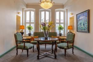 a living room with a table and chairs and a chandelier at The White Brig in Hudiksvall