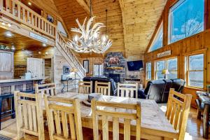 a dining room and kitchen in a cabin with a chandelier at Cabin In The Sky in Epworth