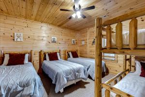 a bedroom with two bunk beds in a log cabin at Cabin In The Sky in Epworth