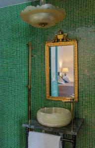 a bathroom with a large mirror and a bath tub at White Brig Guesthouse in Hudiksvall