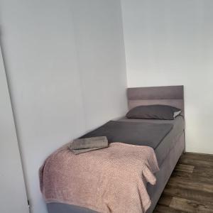 a bedroom with a bed with a blanket on it at Gemütliche Appartement in Bad Oeynhausen