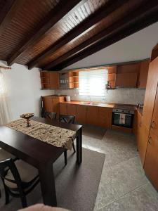 a kitchen with a table and a table and a dining room at The penthouse kastoria in Kastoria +10 photos