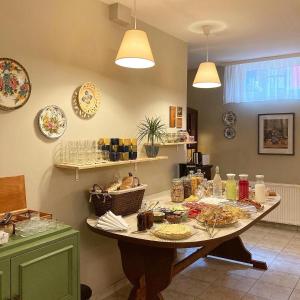a table with plates and dishes on it in a kitchen at Vila Dunavski Raj in Golubac
