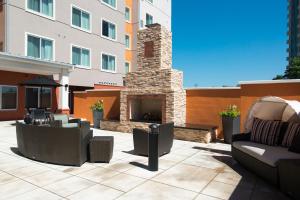 a patio with couches and a stone fireplace at Residence Inn by Marriott Oklahoma City Northwest in Oklahoma City