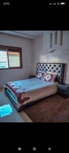 a bedroom with a large bed in a room at FATIMA.MARHABA in Azrou