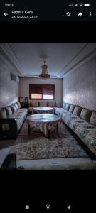 a living room with couches and a table in it at FATIMA.MARHABA in Azrou