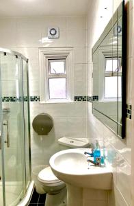 y baño con lavabo, aseo y ducha. en Quality and very good value private accommodation in London close to Notting Hill Zone 2, en Londres