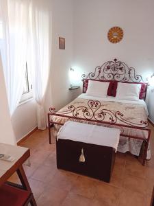 a bedroom with a large bed with a metal headboard at Belli come il Sole in Serri