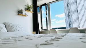 a white bed with a heart made out of rocks on it at Montparnasse, 2 cozy private rooms in shared apartment in Paris