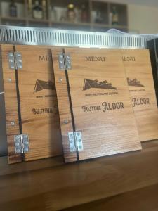 two wooden boxes with the words merril and burninaiden on them at Bujtina ALDOR in Berat
