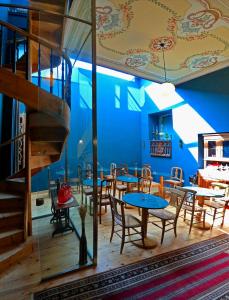 une salle à manger avec des tables et des chaises et un escalier dans l'établissement VASILIKON Hotel 1888 the past is present, à Kalamata