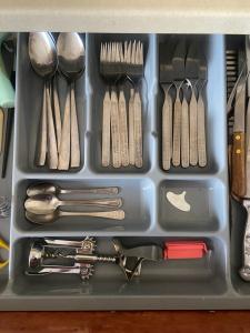 a plastic container filled with utensils and spoons at Laguna in Visaginas