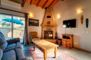 a living room with a couch and a fireplace at Quinta Boa Vida in Alcobaça