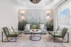 a living room with a couch and two chairs at 27 on Park Boutique Hotel & Venue in Dahlonega