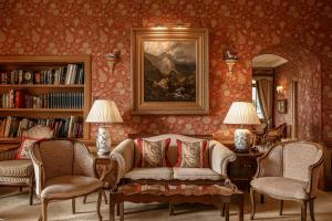 a living room with a couch and two chairs at Kinloch House Hotel in Blairgowrie