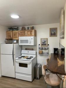 a kitchen with a white stove and a refrigerator at Riverside Retreat in Gold Bar