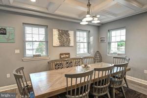 a dining room with a wooden table and chairs at Anchors Away, Your Dream Getaway! in Selbyville