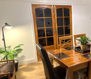 uma sala de jantar com uma mesa de madeira e cadeiras em 3 Bedroom House Near Manchester City centre em Manchester