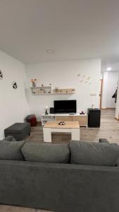 a living room with a couch and a table at La de Fredyy - Tres Marias Apartments in Redondela