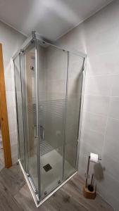a glass shower stall in a room with a toilet paper at La de Fredyy - Tres Marias Apartments in Redondela