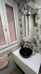 a bathroom with a black sink and a mirror at La de Fredyy - Tres Marias Apartments in Redondela