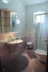 a bathroom with a sink and a toilet and a shower at CasaDilva in Chioggia