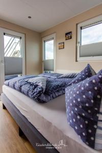 a bedroom with two beds with pillows on it at Hausboot Dory in Ribnitz-Damgarten
