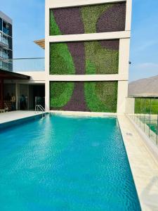 a swimming pool in front of a building at Salinas Del Mar - Pozos Colorados - By INMOBILIARIA VS in Santa Marta