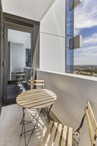 a balcony with a table and chairs on a building at Atop the Melbourne CBD with Panoramic Views in Melbourne