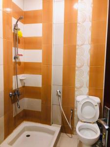 a small bathroom with a toilet and a shower at MOHAMMAD HOSTEL in Muscat
