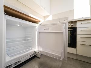 an empty kitchen with an empty refrigerator at Spacious Apartments with View & Free Parking in Wiener Neustadt