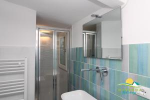 a bathroom with a shower and a toilet and a sink at Acquamarina B&Beach in Follonica +25 photos