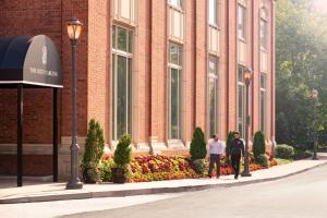 two people standing in front of a brick building at The Ritz-Carlton, St. Louis in Clayton