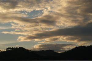 a cloudy sky with trees in the background at Hostal Casa Verde in Santa Ana +11 photos