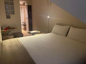 a bedroom with a white bed and a window at Vittorio 73 Luxury Apartment in Turin