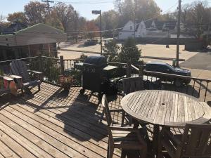 a grill and a table and chairs on a deck at Entire apartment close to downtown - 2 queen beds in Springfield