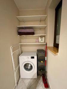 a washer and dryer in a small room at Loft B - duża przestrzeń, cisza, szybki internet in Krakow