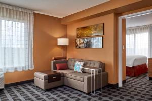 sala de estar con sofá y cama en TownePlace Suites by Marriott Fort McMurray en Fort McMurray